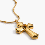 Ember Cross Necklace in 18K gold plating with a warm amber center stone
