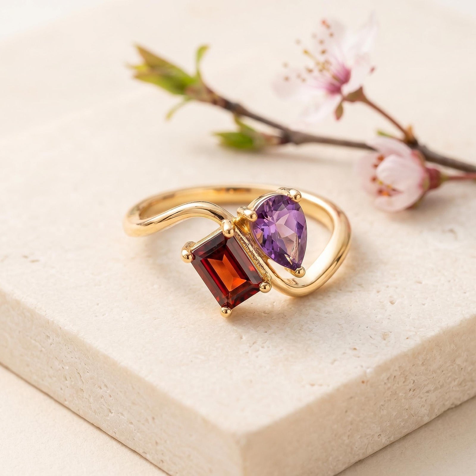 Two stone birthstone ring macro detail with square and water drop stones