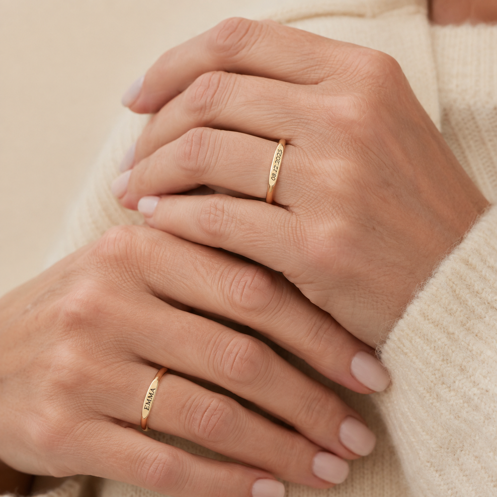 Two Gold rings personalized with a name and meaningful date