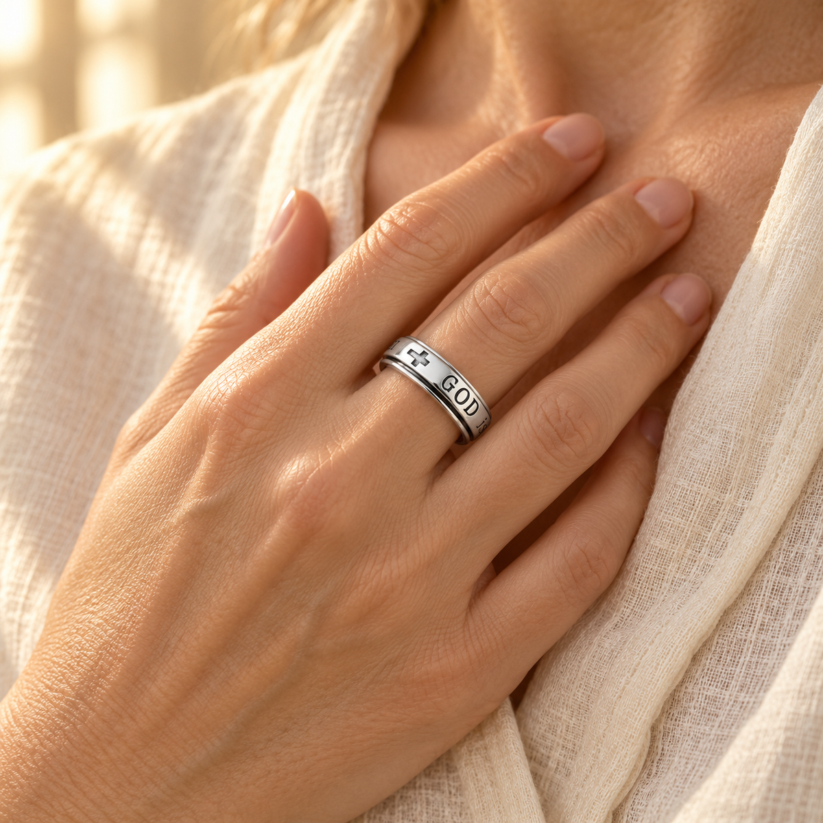 Woman wearing the She Will Not Fall Ring with her hand resting over her heart