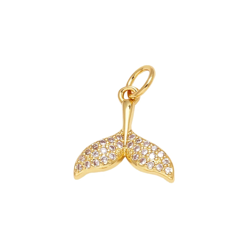 Crystal Whale Tail Dangle Charm in gold-plated copper on white background