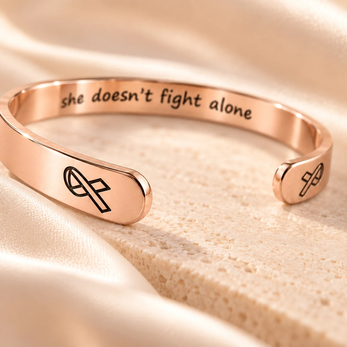Rose gold breast cancer cuff macro detail with awareness ribbon ends