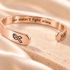Rose gold cancer-support cuff macro detail with ribbon engravings