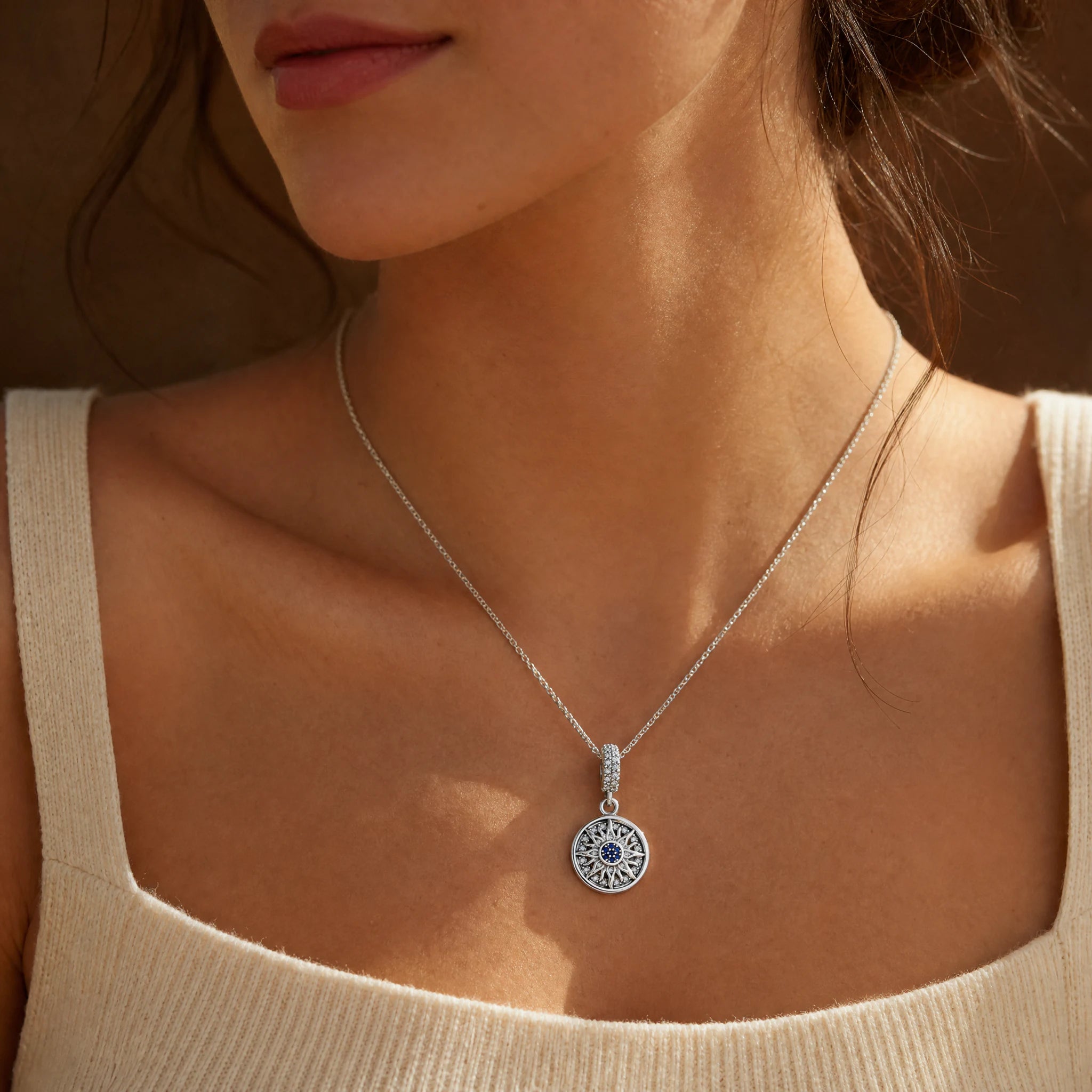 Blue Celestial Sun Medallion Dangle Charm worn on a delicate necklace