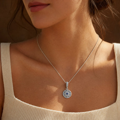 Blue Celestial Sun Medallion Dangle Charm worn on a delicate necklace