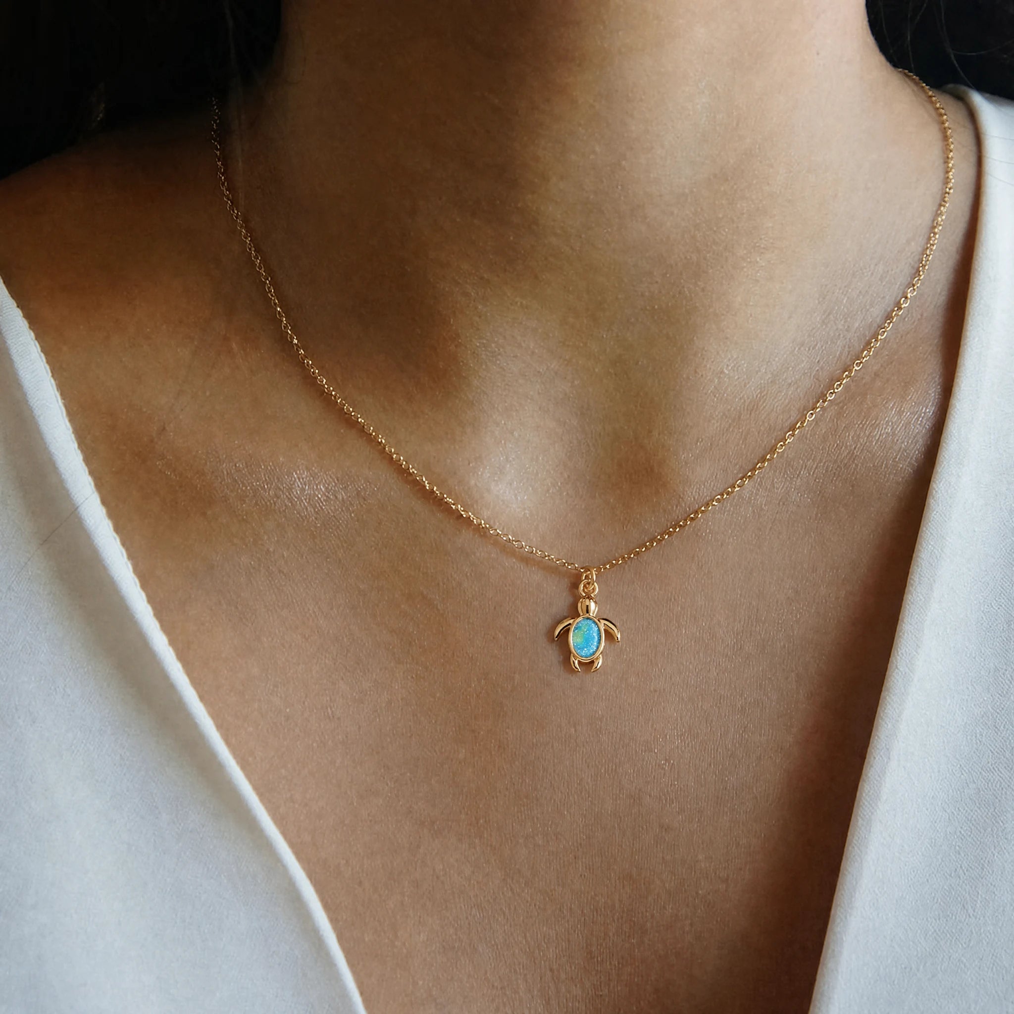 Blue Sea Turtle Crystal Dangle Charm worn on a delicate necklace