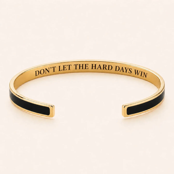 Don't Let The Hard Days Win cuff bracelet - Gold finish, Black enamel, full quote