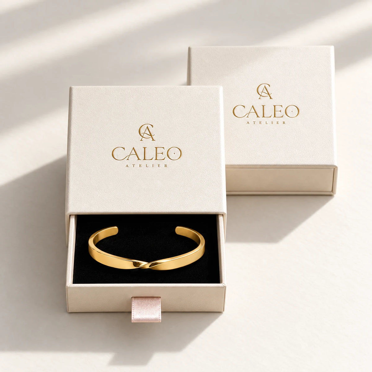 Custom Engraved Twist Cuff presented in CALEO Atelier ivory jewelry packaging