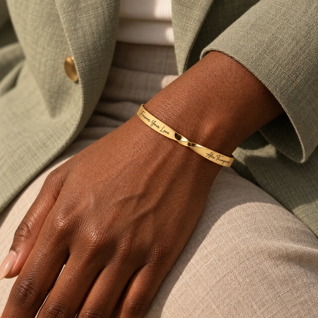 Gold Custom Engraved Twist Cuff worn by Black model in sage linen blazer