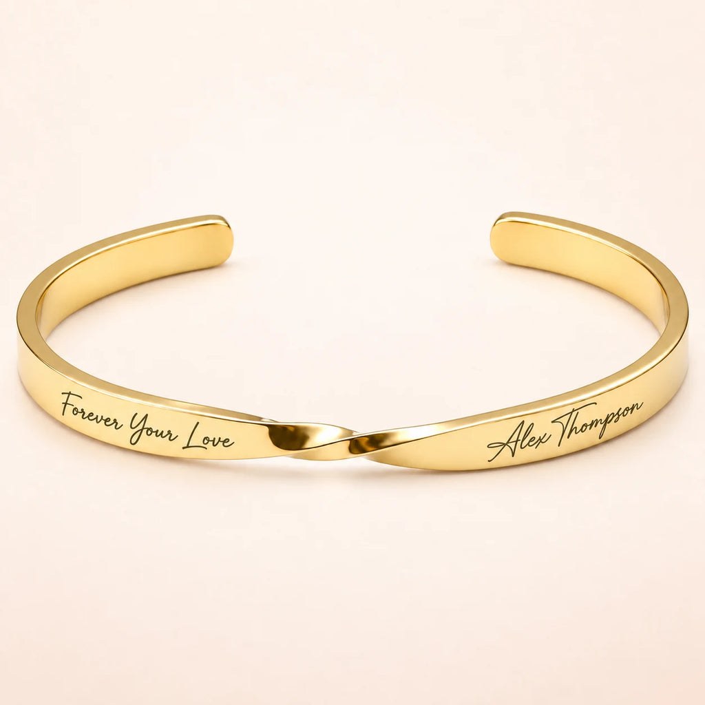 Gold Custom Engraved Twist Cuff Bracelet on blush ivory background
