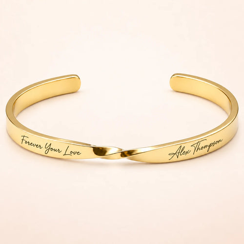 Gold Custom Engraved Twist Cuff Bracelet on blush ivory background