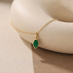 CALEO dangle lifestyle image - Gold Green Hamsa Hand Dangle Charm - dangle-one-thumb-ref01-gold-green-hamsa-hand-dangle-charm - 2026-07-24