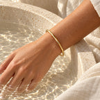Water-resistant Aurelia Essential Bangle with water droplets