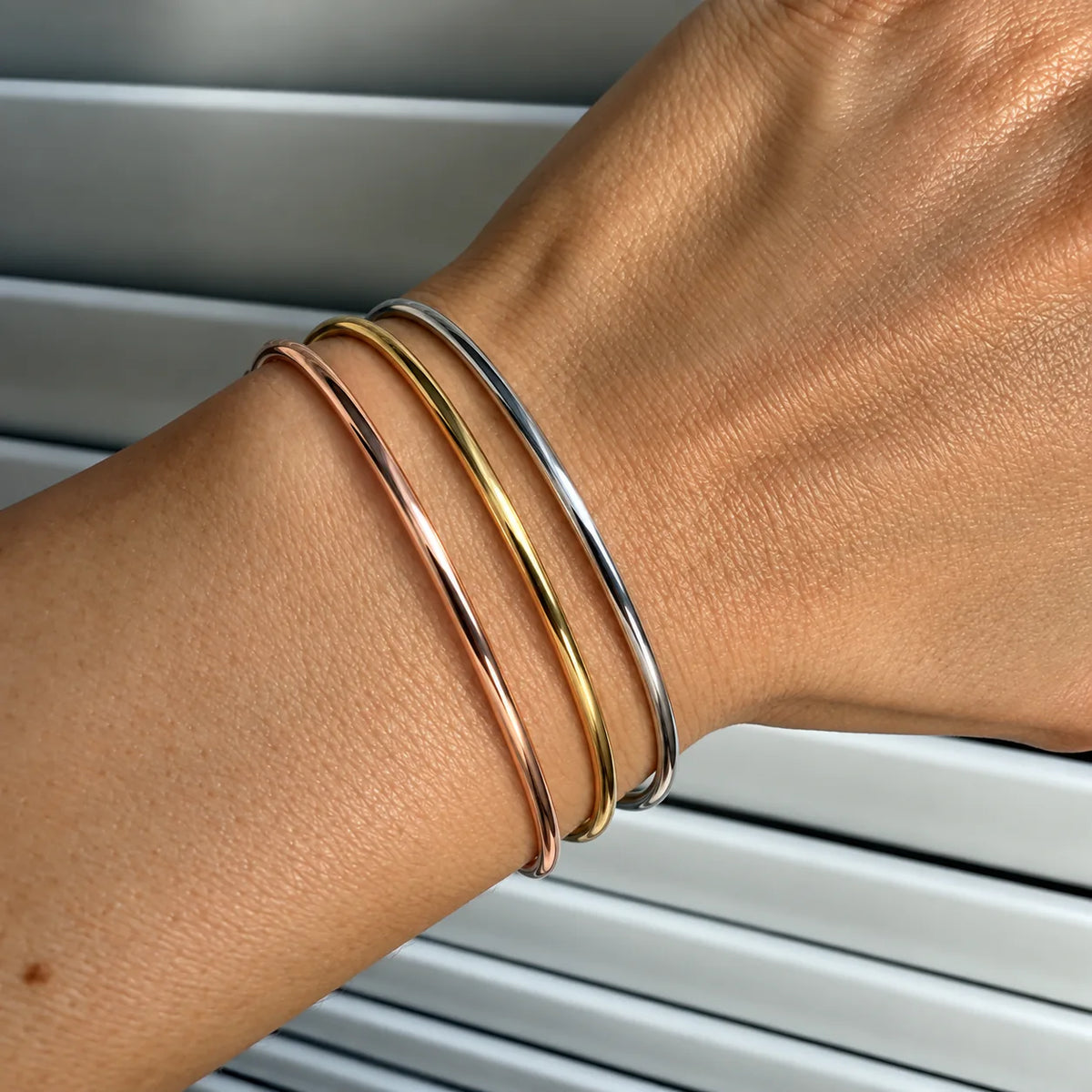 Gold, Rose Gold and Silver Aurelia bangles worn together