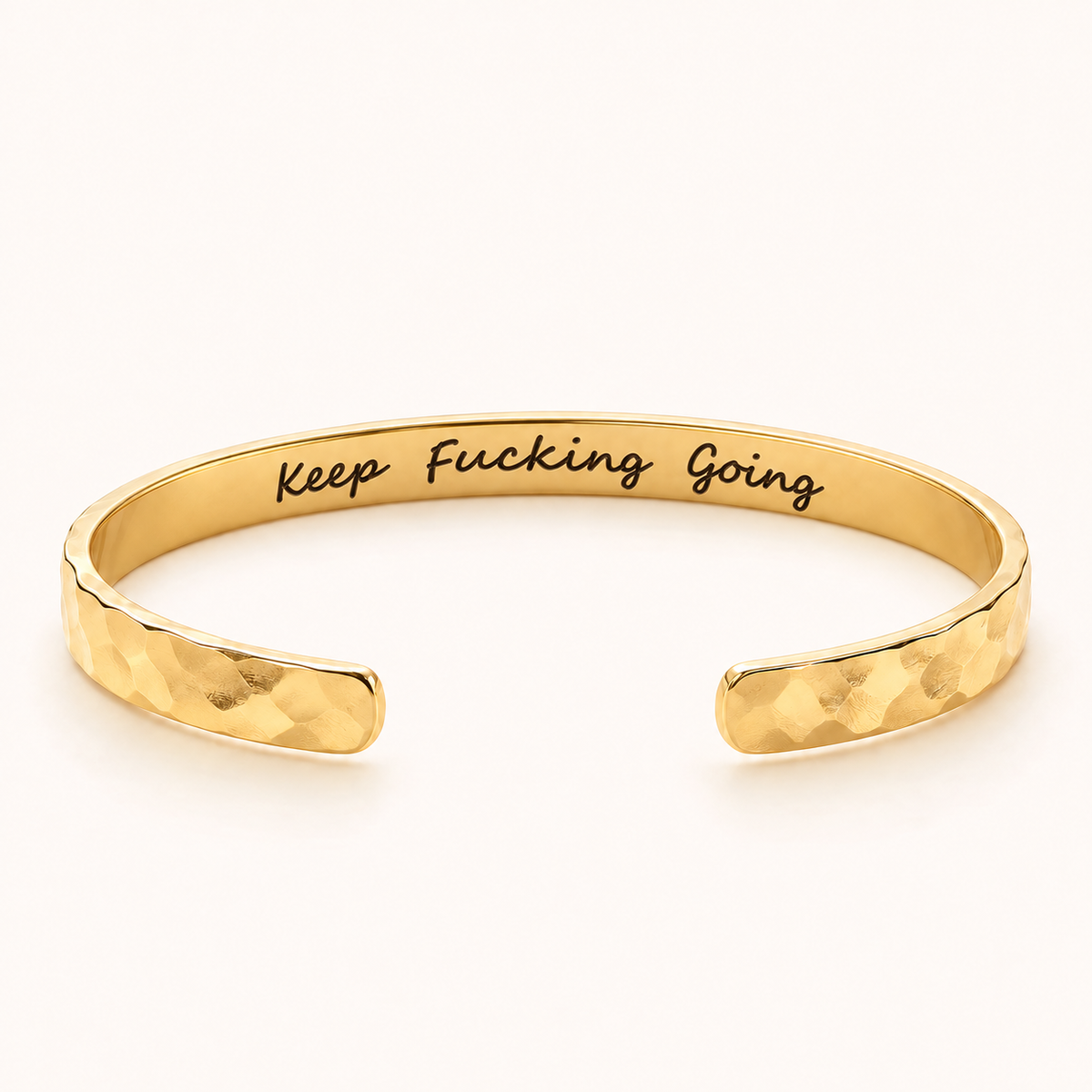 Gold hammered cuff with Keep Fucking Going private inside engraving