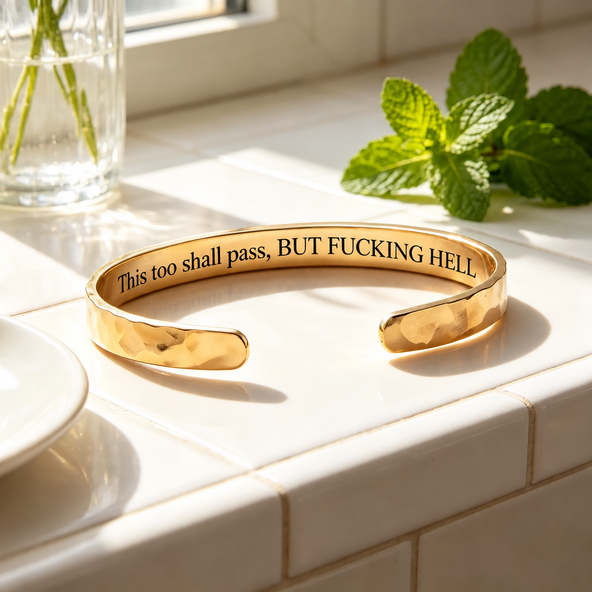 Gold hammered cuff with private engraving in a sunlit setting