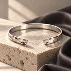 Silver This Too Shall Pass Hammered Cuff worn in a refined editorial portrait