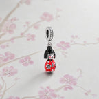 CALEO Japonism lifestyle image - Red Kokeshi Doll Dangle Charm - japonism-refbatch-ref09-red-kokeshi-doll-dangle-charm - 2026-07-27