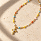 Joyful Grace Cross Necklace - flatlay gold limestone