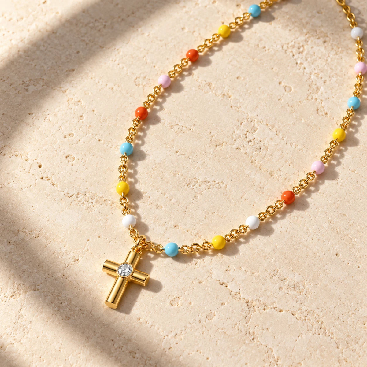 Joyful Grace Cross Necklace - flatlay gold limestone