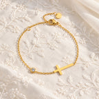 Luminous Faith Cross Bracelet - flatlay embroidered fabric