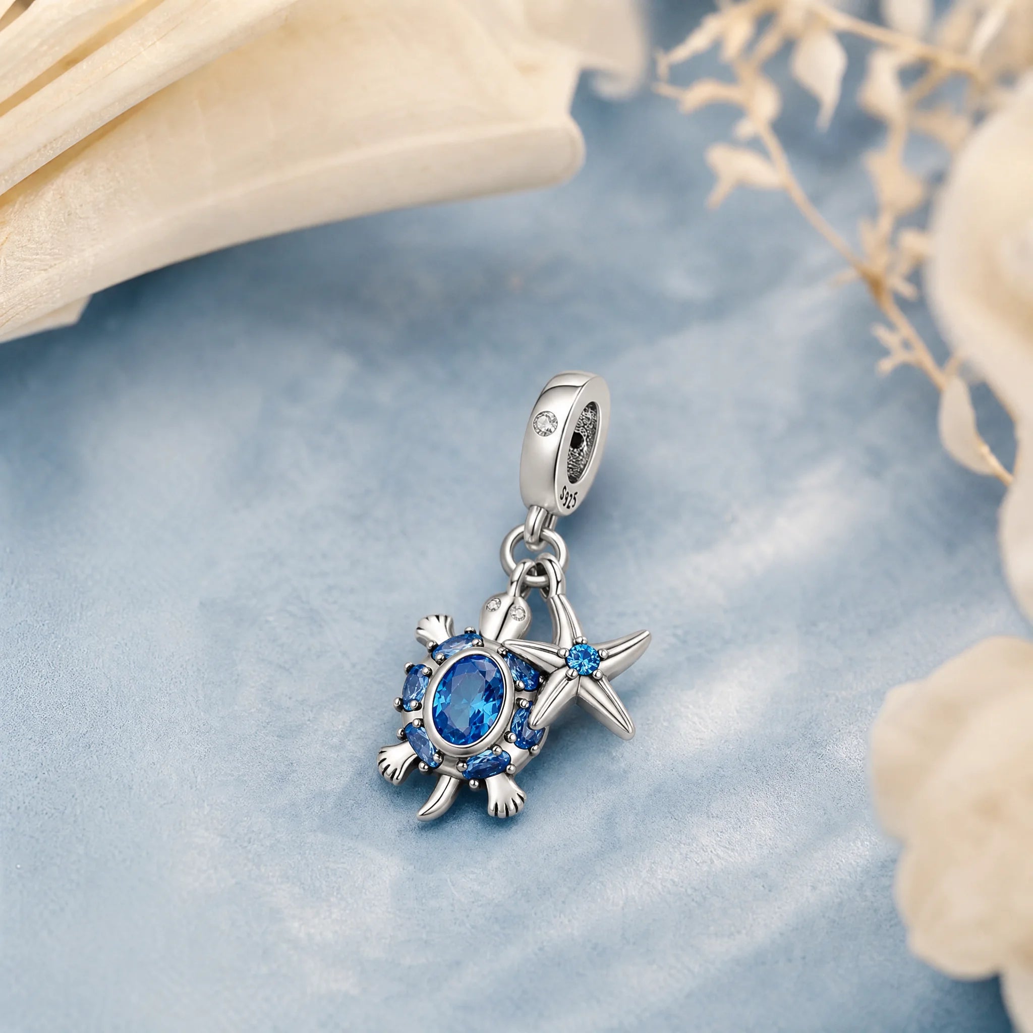 CALEO Nature & Flowers color-matched lifestyle image - Blue Starfish & Compass Dangle Charm - nature-flowers-color-blue-ref04-blue-starfish-compass-dangle-charm - 2026-07-27