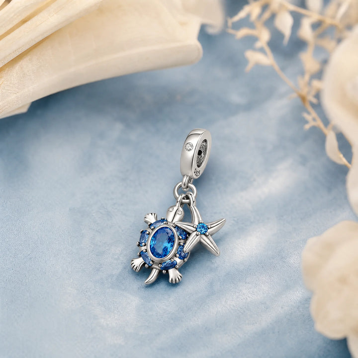 CALEO Nature & Flowers color-matched lifestyle image - Blue Starfish & Compass Dangle Charm - nature-flowers-color-blue-ref04-blue-starfish-compass-dangle-charm - 2026-07-27