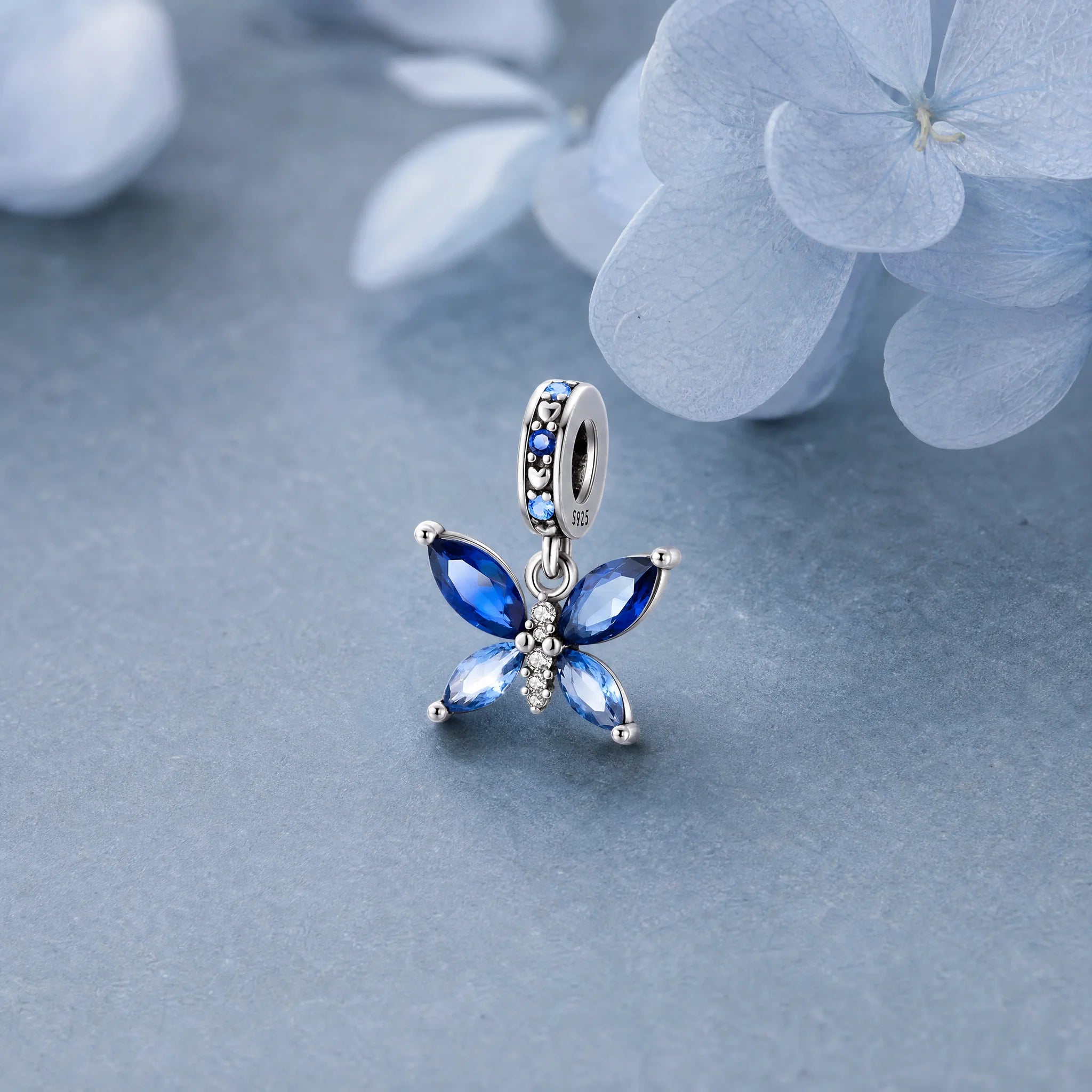 CALEO Nature & Flowers color-matched lifestyle image - Blue Crystal Butterfly Dangle Charm - nature-flowers-color-blue-ref10-blue-crystal-butterfly-dangle-charm - 2026-07-27