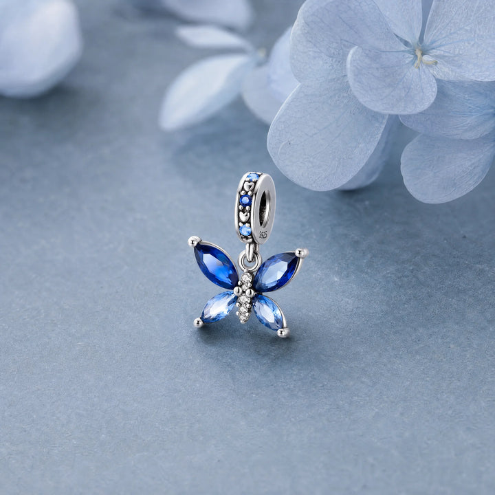 CALEO Nature & Flowers color-matched lifestyle image - Blue Crystal Butterfly Dangle Charm - nature-flowers-color-blue-ref10-blue-crystal-butterfly-dangle-charm - 2026-07-27