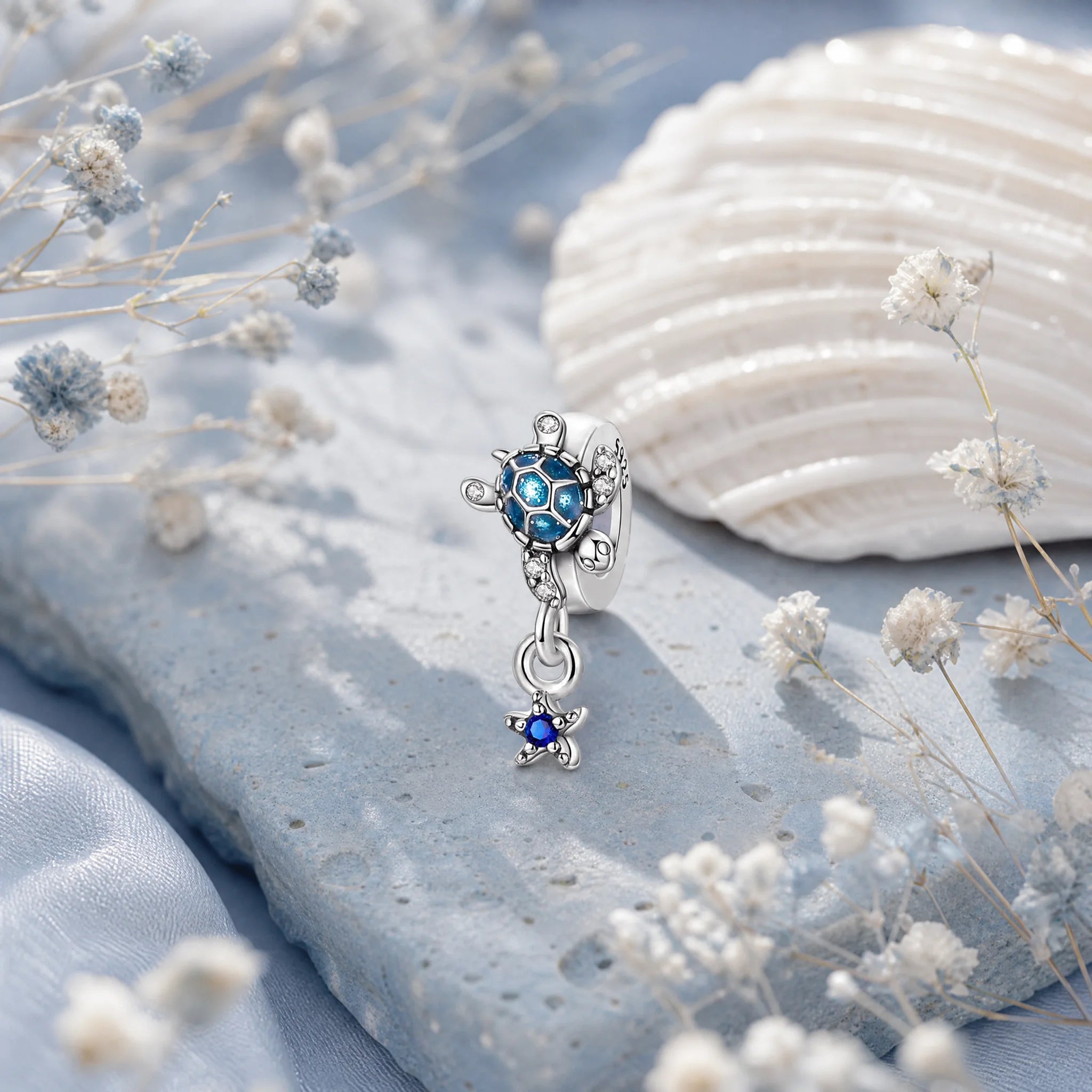 CALEO Nature & Flowers color-matched lifestyle image - Blue Starfish & Dolphin Dangle Charm - nature-flowers-color-blue-ref18-blue-starfish-dolphin-dangle-charm - 2026-07-27
