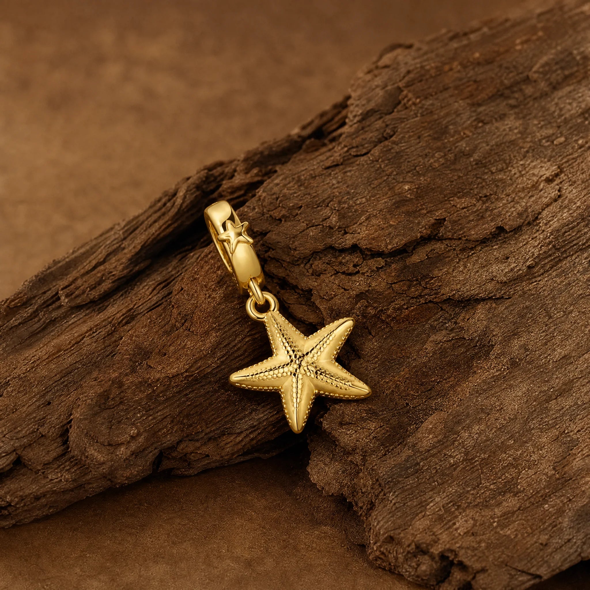 CALEO Nature & Flowers color-matched lifestyle image - Gold Starfish Dangle Charm - nature-flowers-color-gold-ref25-gold-starfish-dangle-charm - 2026-07-27