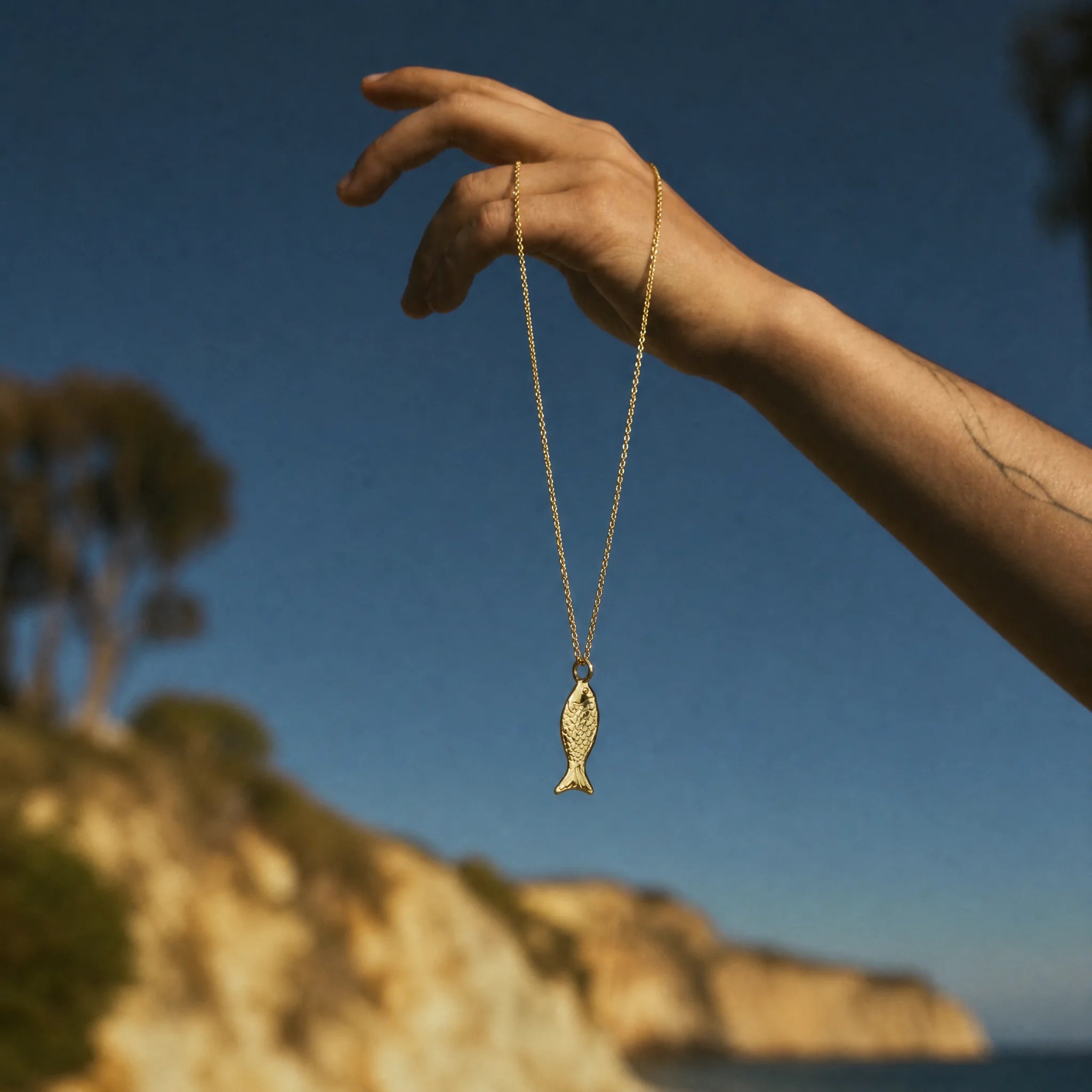 CALEO ocean lifestyle image - Gold Mini Fish Pendant Charm - ocean-extra-ref07-gold-mini-fish-pendant-charm - 2026-07-23