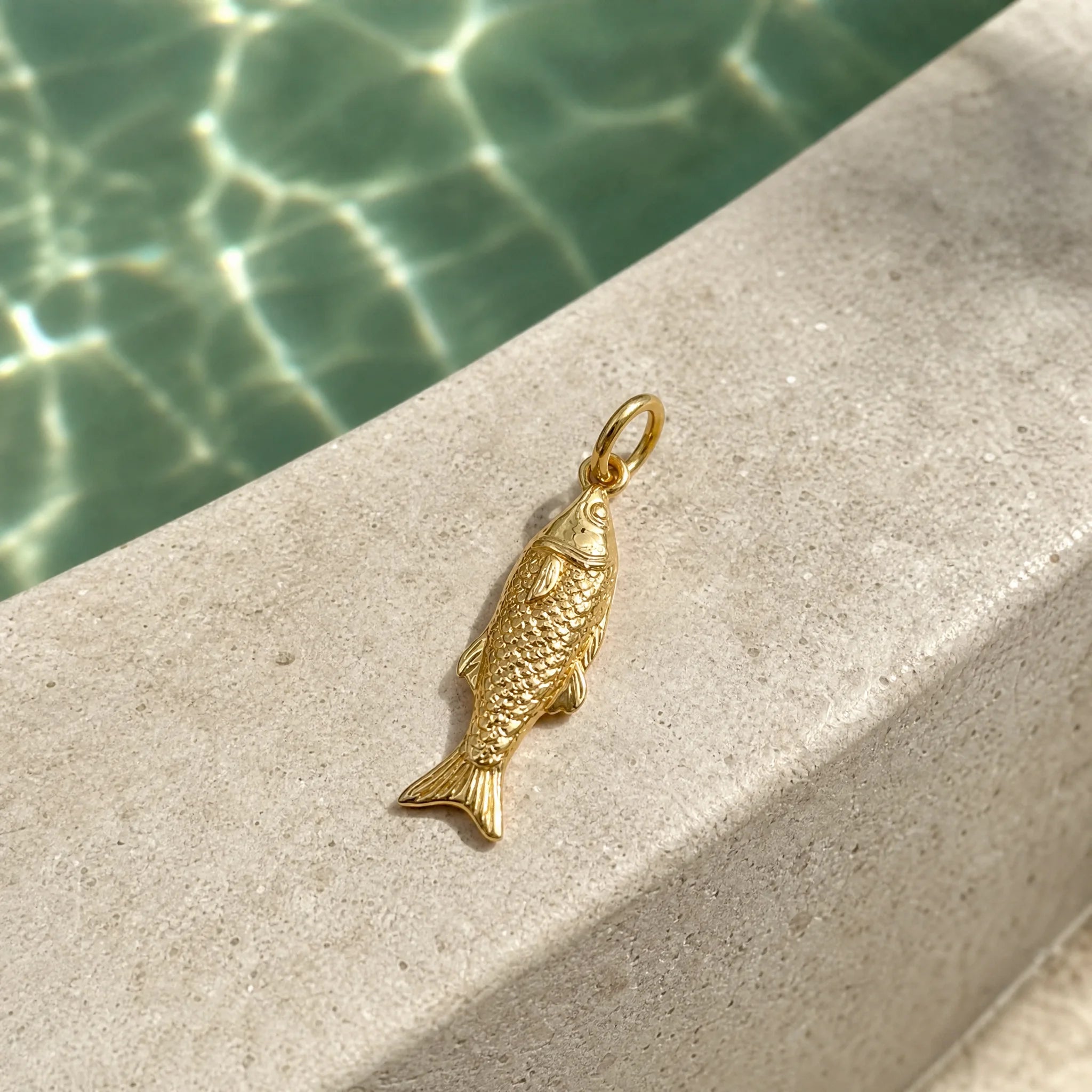 CALEO ocean lifestyle image - Gold Petite Fish Pendant Charm - ocean-ref20-gold-petite-fish-pendant-charm - 2026-07-23