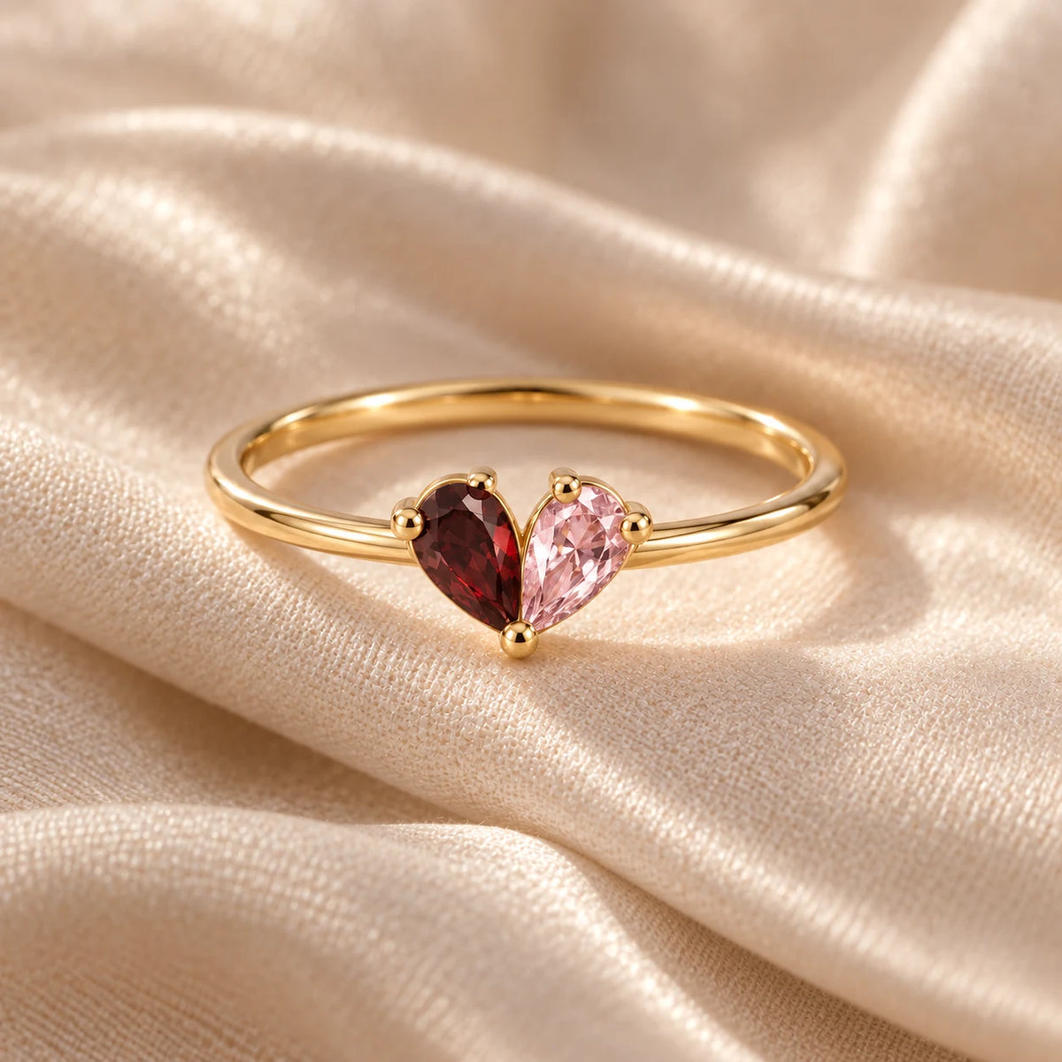 Gold two-birthstone heart ring with garnet and pink birthstones