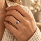 Woman wearing a gold personalised two-birthstone heart ring