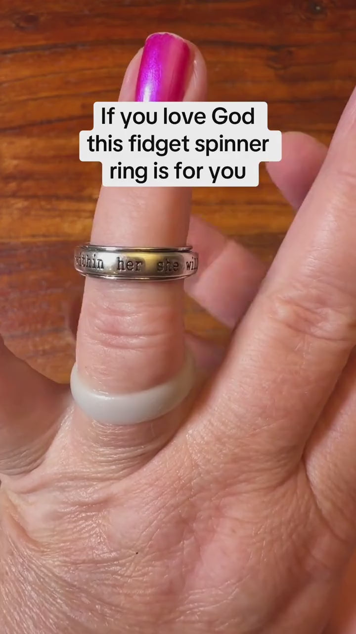 The rotating band of the She Will Not Fall Ring demonstrated by hand