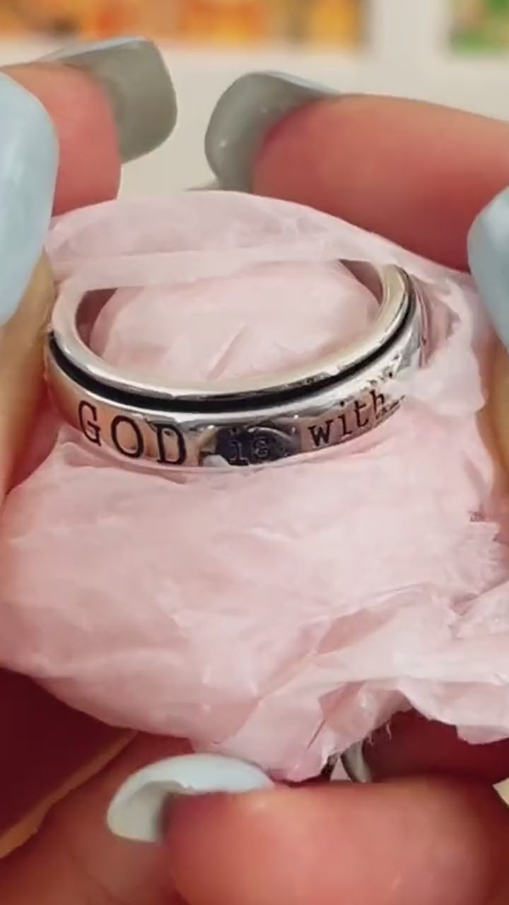 Warm close-up of the ring's engraved message and cross detail