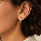 Radiant Cross Huggie Hoops - lifestyle ear gold