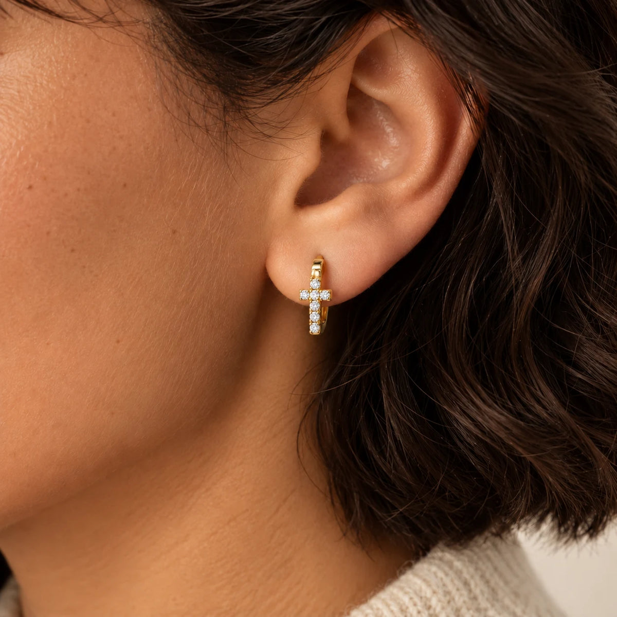 Radiant Cross Huggie Hoops - lifestyle ear gold