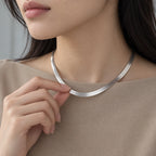 Radiant Herringbone Choker - lifestyle silver hand sand top