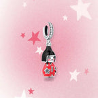 CALEO Japanese charm thumbnail - Red Kokeshi Doll Dangle Charm - pink star background - 2026-07-22