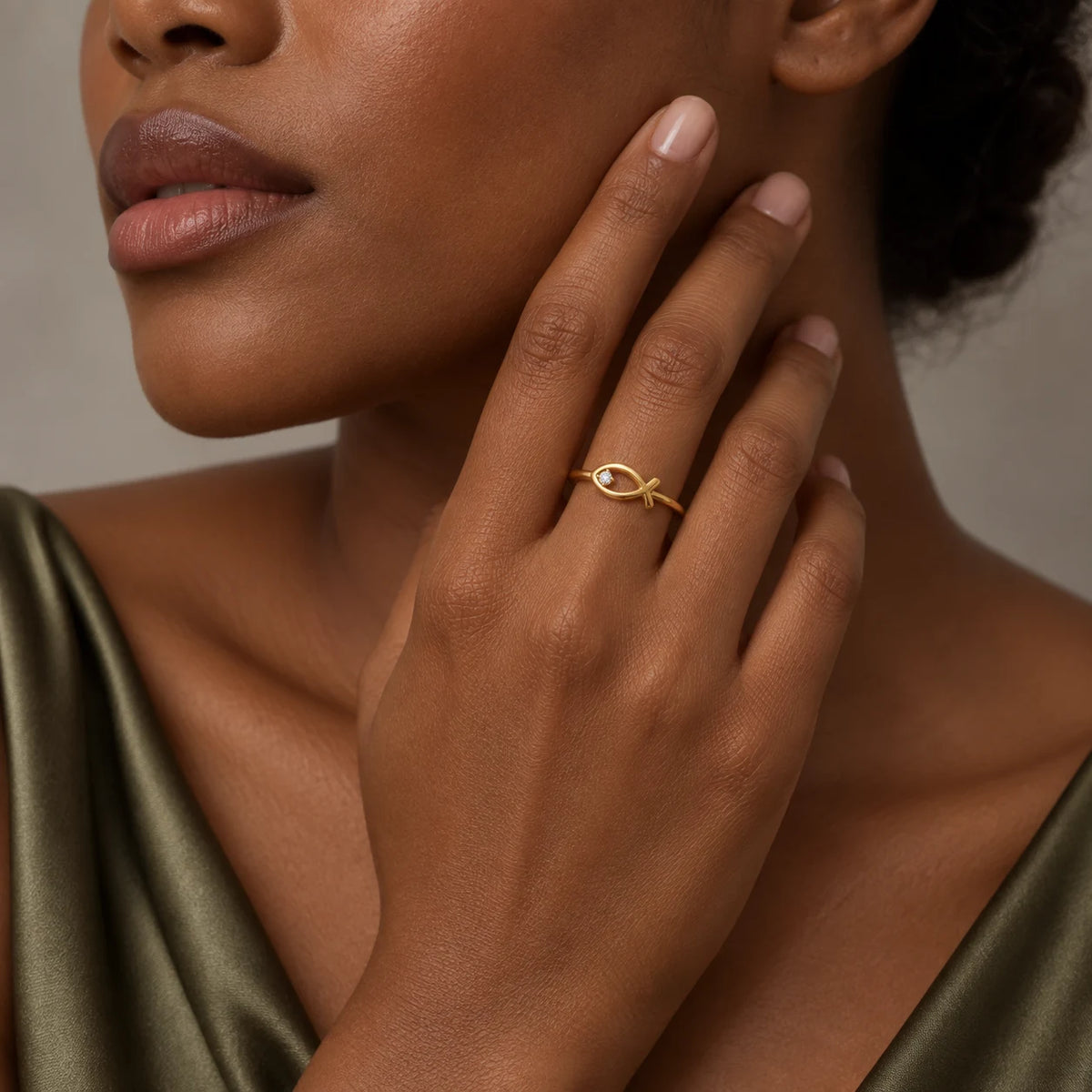 Woman wearing a gold Christian fish symbol ring from the CALEO Christian Jewelry collection