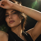 Gold This Too Shall Pass Letter Bracelet worn in a luxury editorial portrait