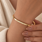 Gold This Too Shall Pass Slim Cuff with exterior engraving worn on the wrist