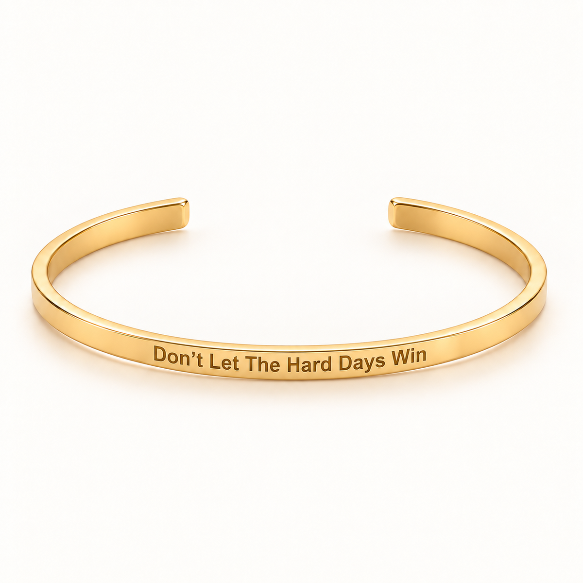 Gold open Slim Cuff with Don't Let The Hard Days Win engraved on the outside
