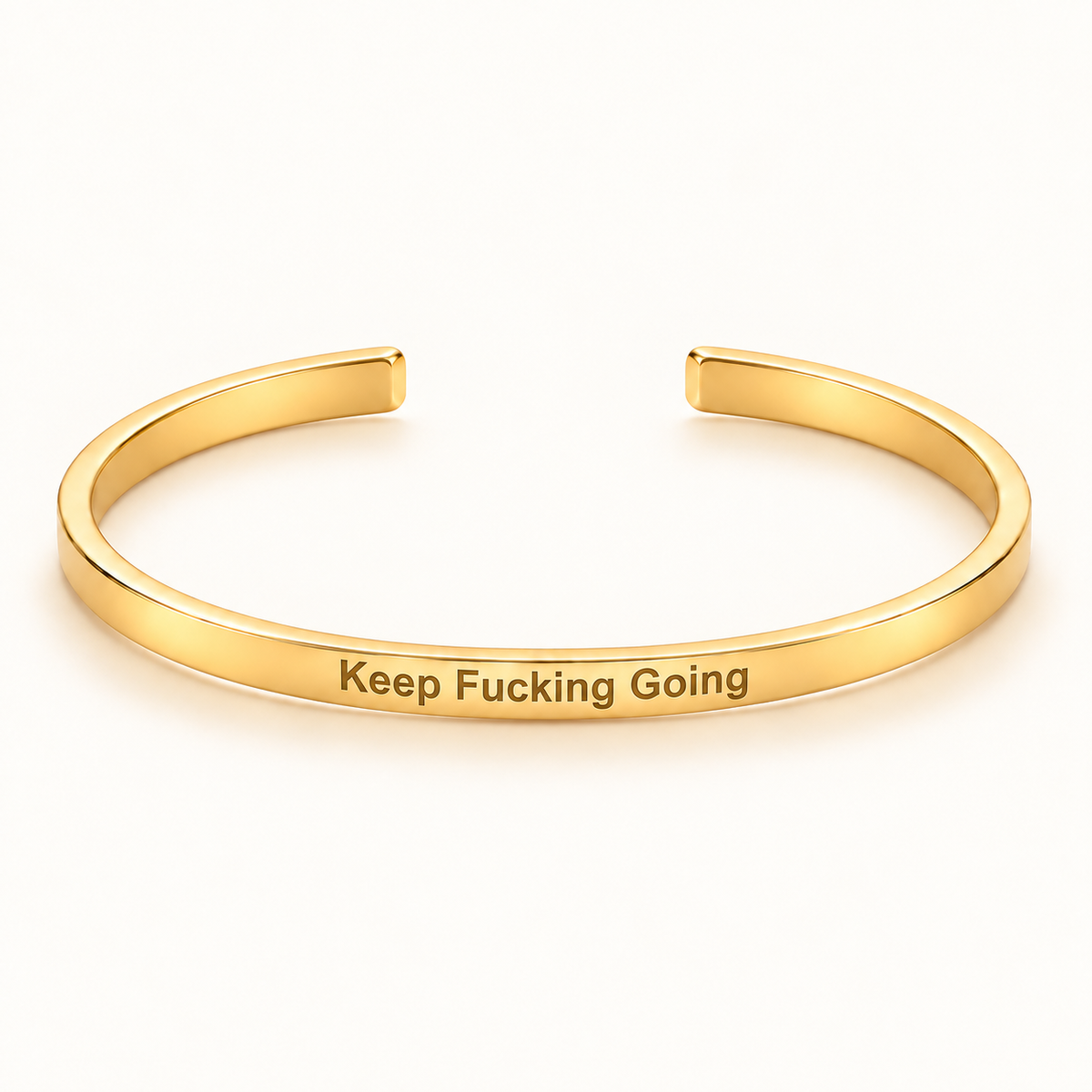 Gold open Slim Cuff with Keep Fucking Going engraved on the outside