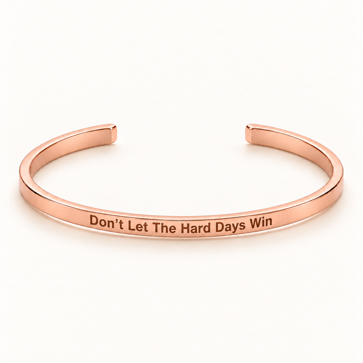 Rose Gold open Slim Cuff with Don't Let The Hard Days Win engraved on the outside
