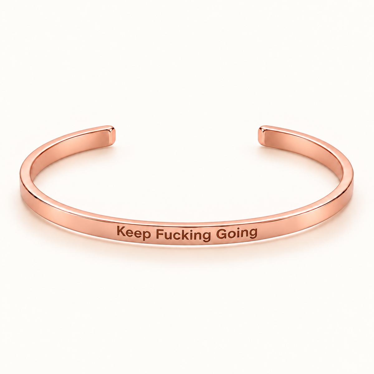 Rose Gold open Slim Cuff with Keep Fucking Going engraved on the outside