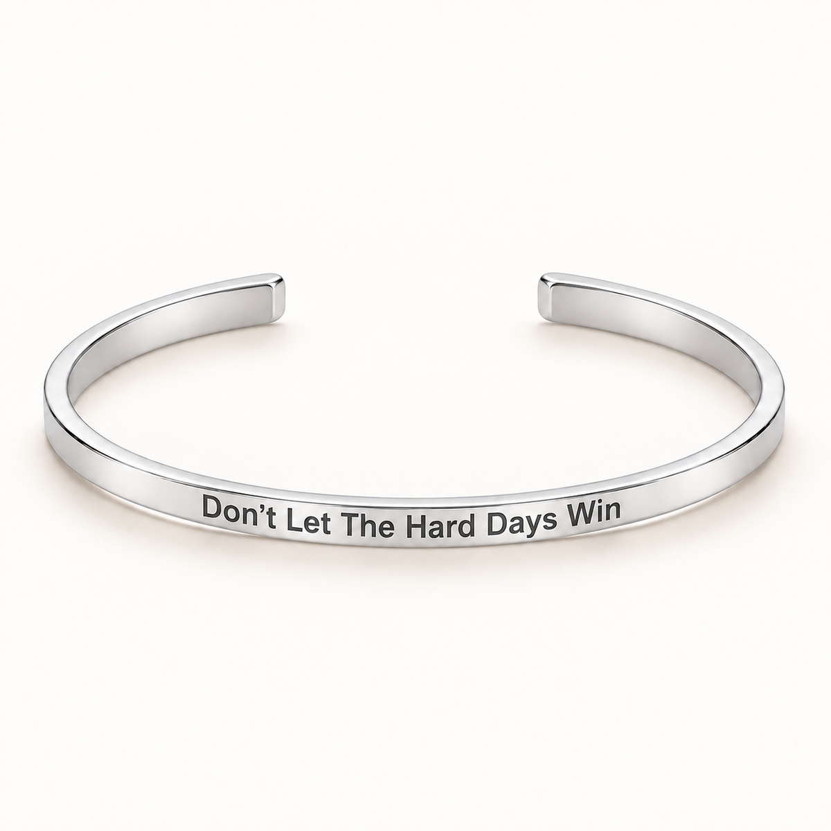 Silver open Slim Cuff with Don't Let The Hard Days Win engraved on the outside