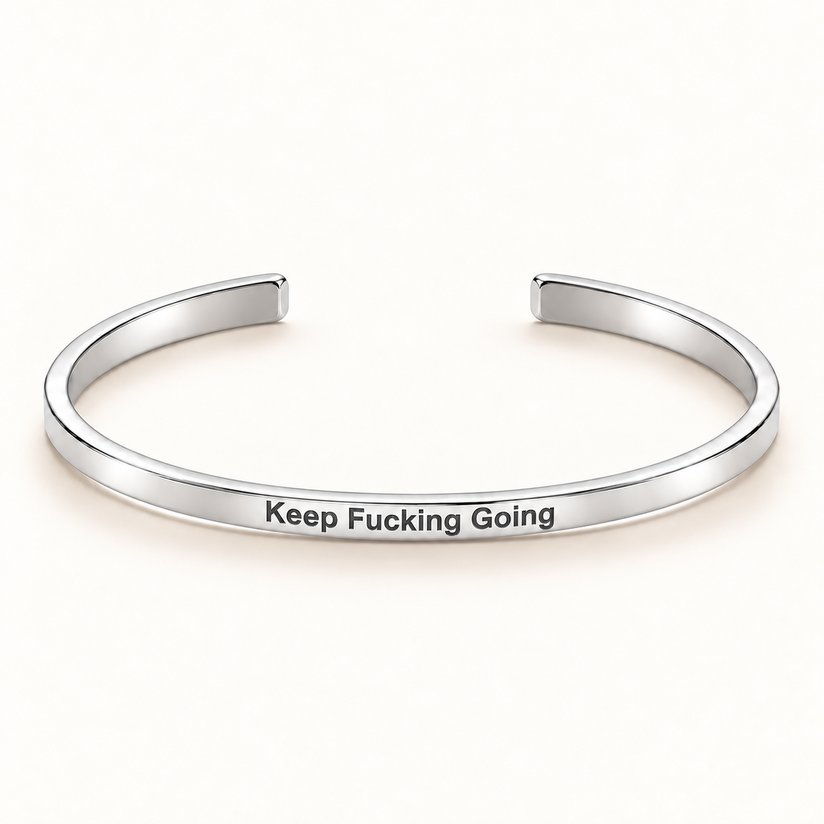 Silver open Slim Cuff with Keep Fucking Going engraved on the outside